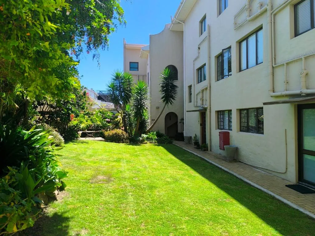 Spacious garden courtyard with lush green lawn and manicured landscaping