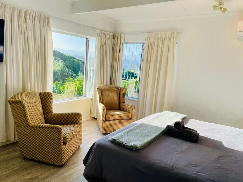 Spacious bedroom with mountain and valley views through large windows