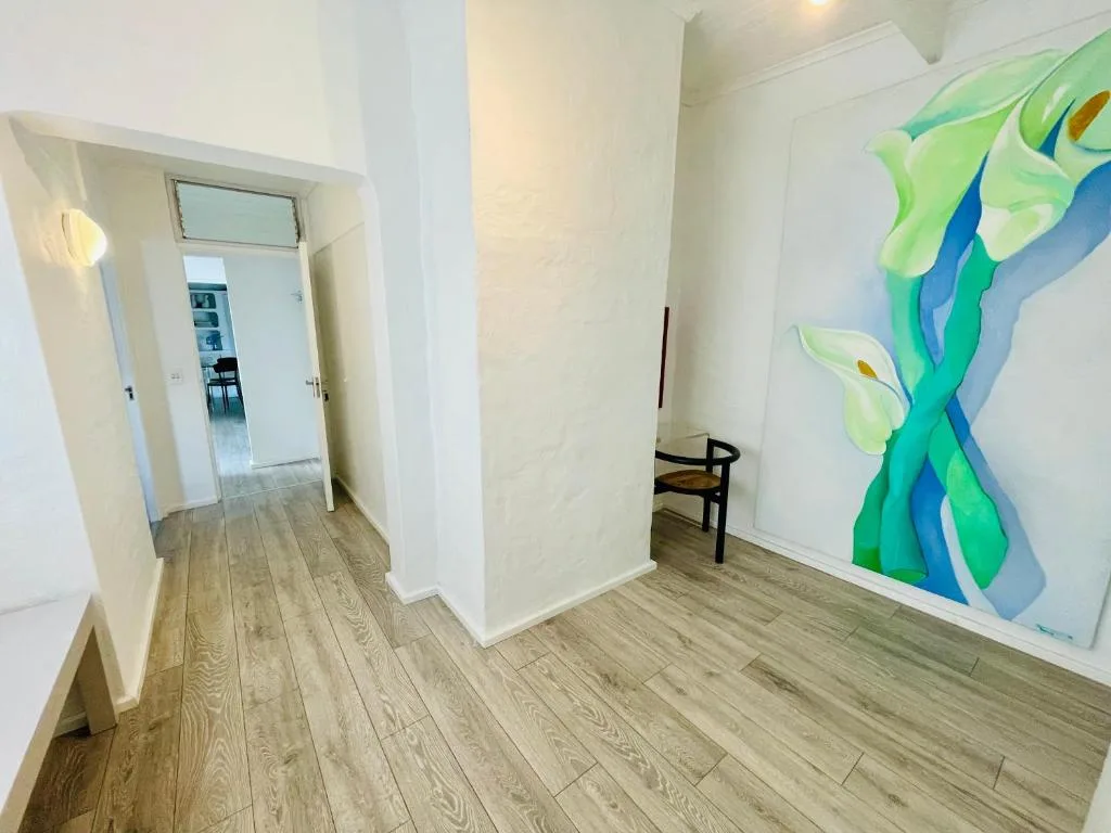 Modern hallway with wooden floors and contemporary wall art decoration