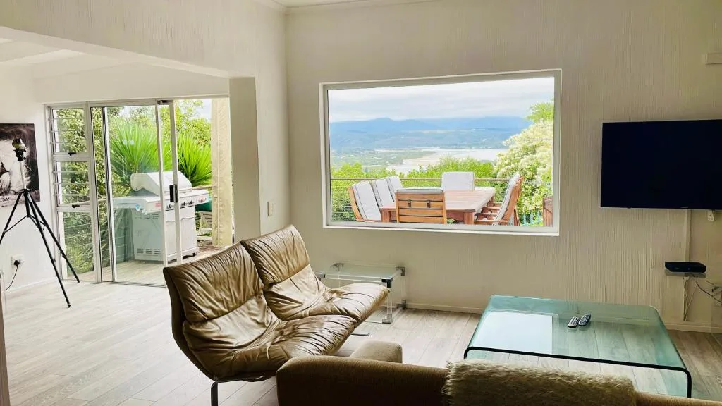 Modern lounge with leather seating and expansive mountain and ocean views