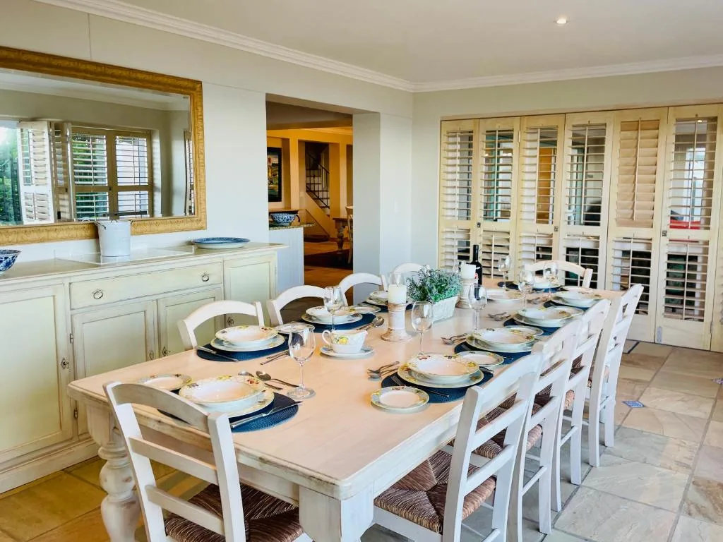 Elegant dining room with long table set for eight guests