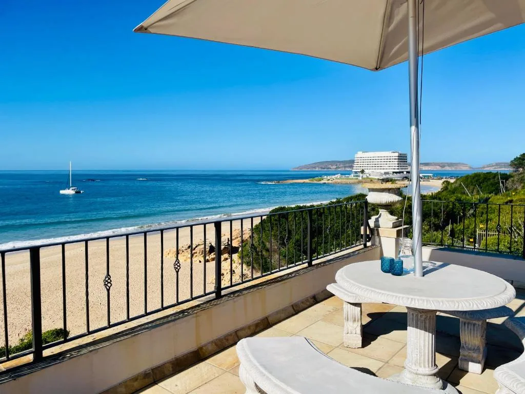 Stunning ocean and beach vista from shaded coastal deck