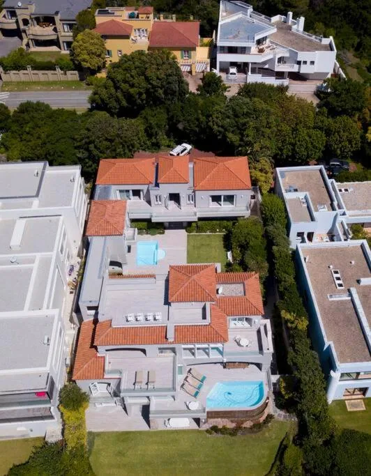 Aerial view of modern villa with terracotta roof and swimming pool