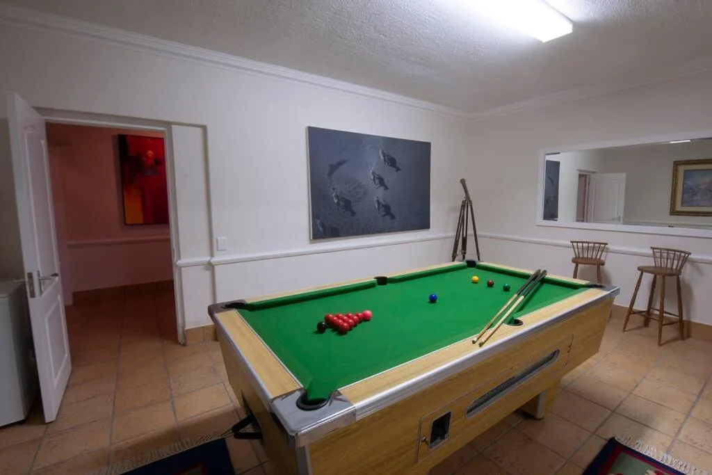 Recreation room with pool table, wall art, and bar seating area