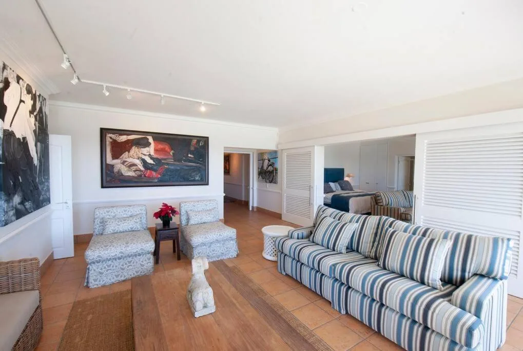 Spacious living room with striped sofas and comfortable seating areas