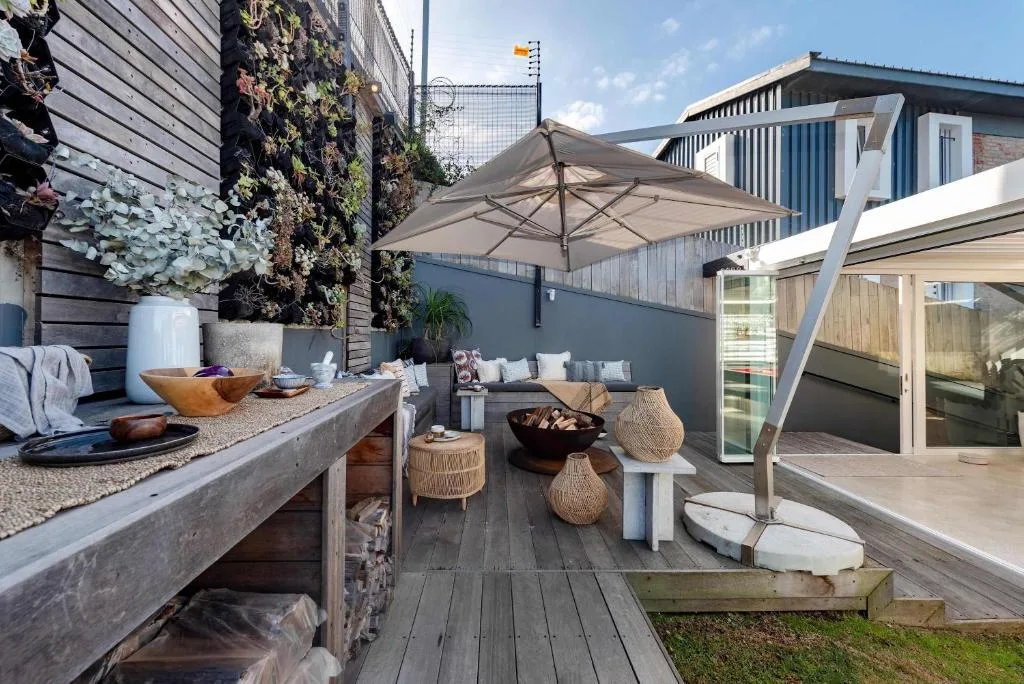 Modern outdoor deck with umbrella, fire pit, and contemporary seating area