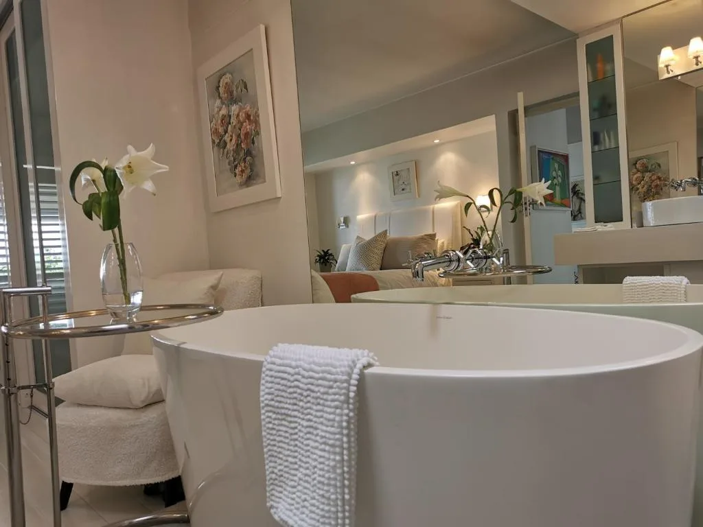 Luxurious modern bathroom with freestanding white soaking tub and vanity mirror