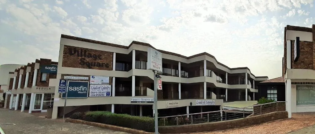 Multi-story apartment building with curved architectural design and brick base