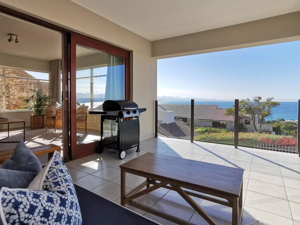 Expansive terrace with ocean views, braai grill, and outdoor seating area