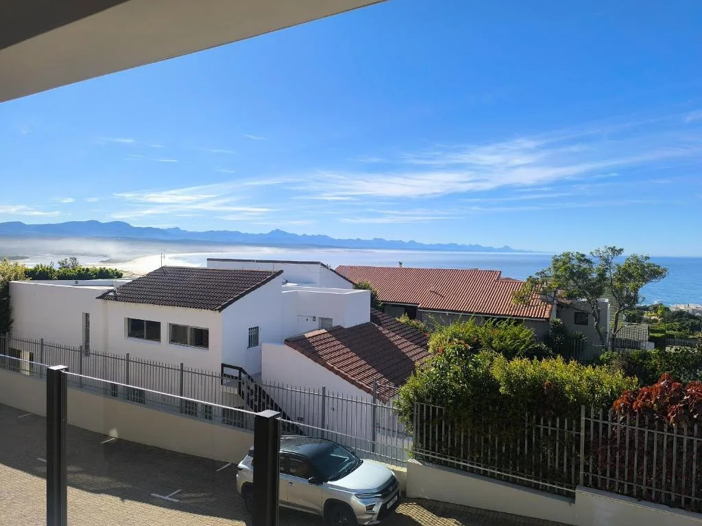 Ocean and mountain vista from property deck overlooking Plettenberg Bay coastline