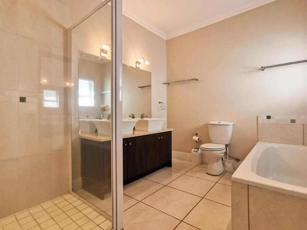 Spacious bathroom with walk-in shower, double vanity, and soaking tub
