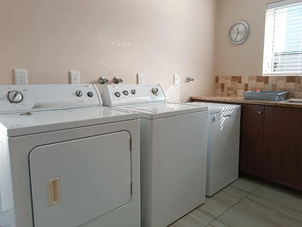Laundry room with washer, dryer, and utility sink