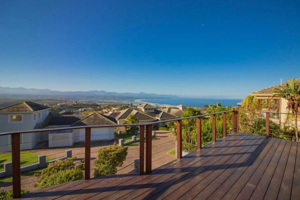 Panoramic coastal view from elevated deck overlooking lagoon and mountains