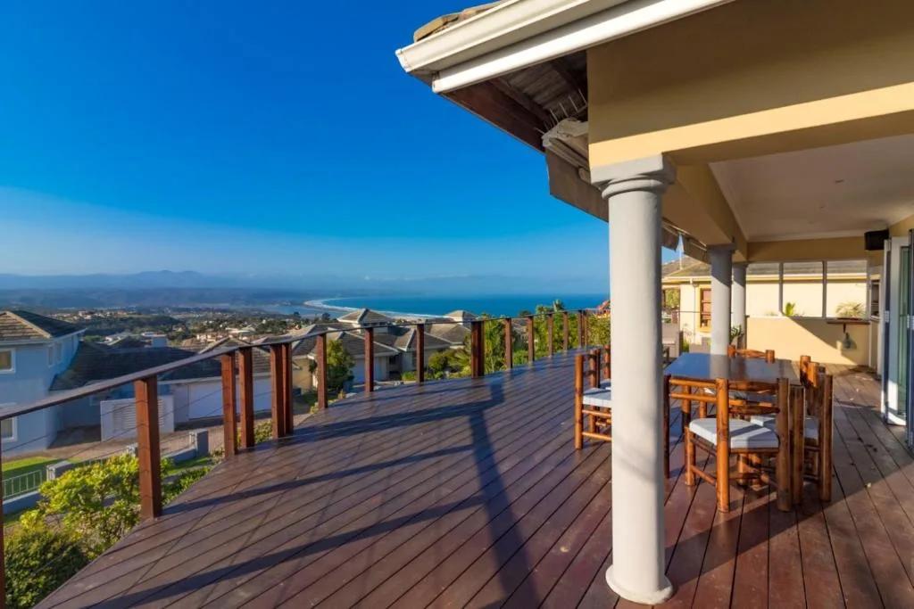 Expansive coastal view of Plettenberg Bay and ocean from elevated deck