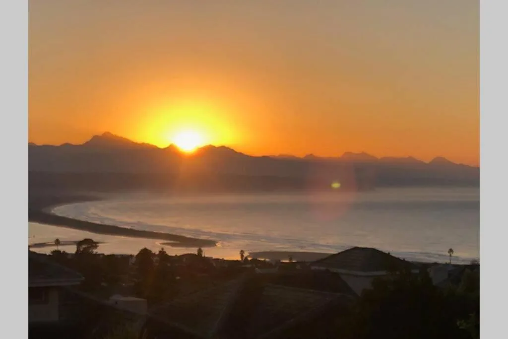 Stunning sunset over Plettenberg Bay with mountains and lagoon