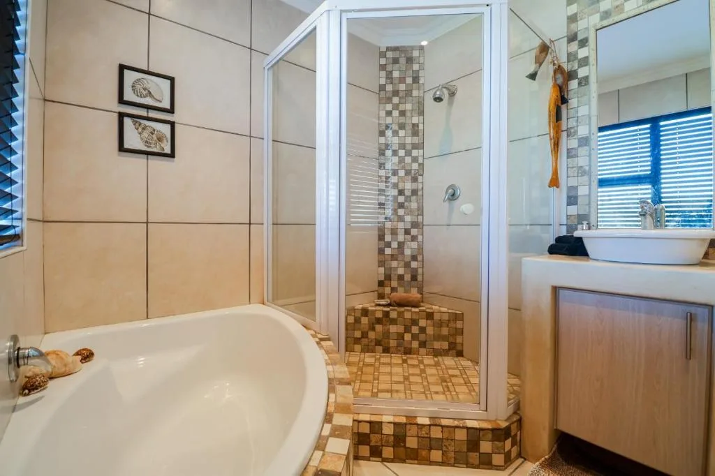 Modern bathroom with soaking tub, walk-in shower, and vessel sink vanity