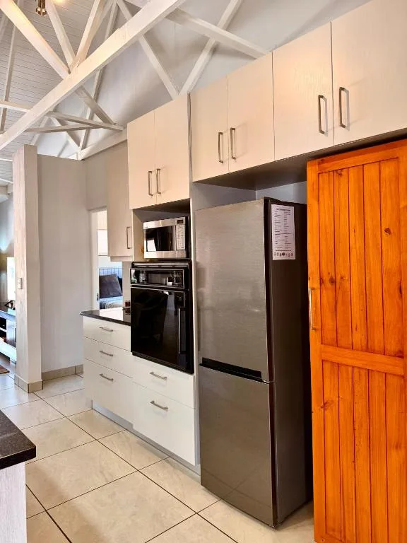 Modern kitchen with stainless steel appliances and cream cabinetry