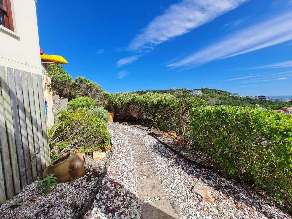 Garden Route property exterior with coastal garden path and hillside views