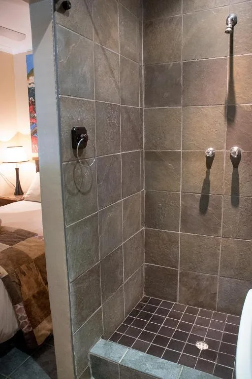 Modern walk-in shower with slate tiling and chrome fixtures