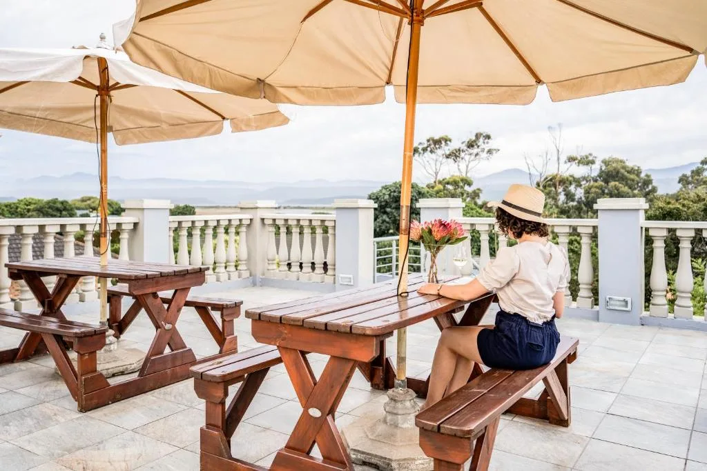 Shaded outdoor seating area with picnic tables and mountain views