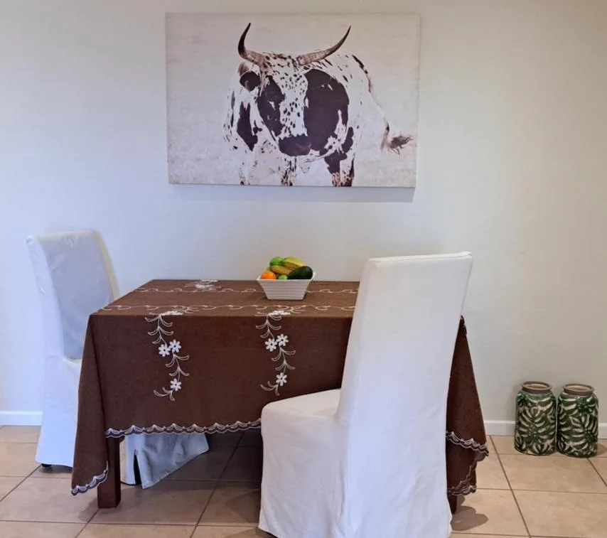 Styled dining table with decorative cloth and artwork on wall