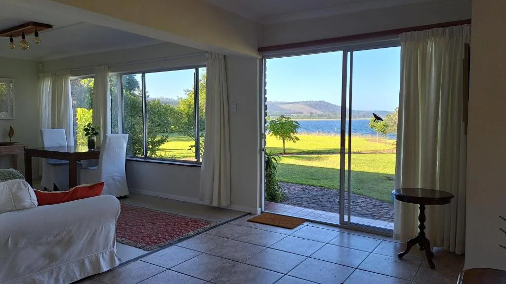Scenic water and mountain vista through large glass doors and windows