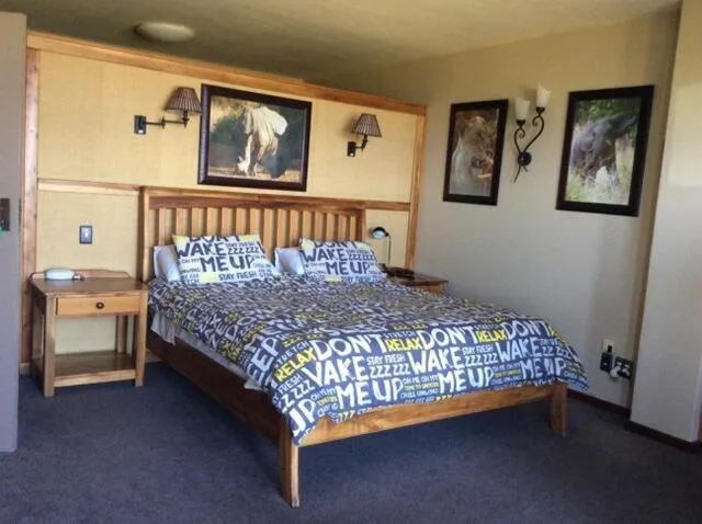 Wooden bed with blue patterned bedding and matching pillows in bedroom