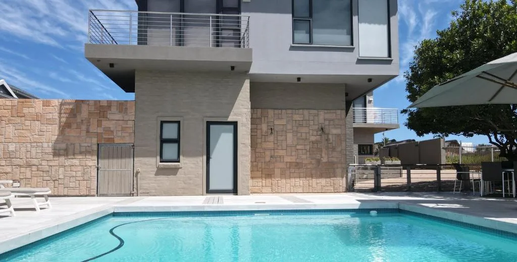 Modern house with swimming pool and stone facade exterior