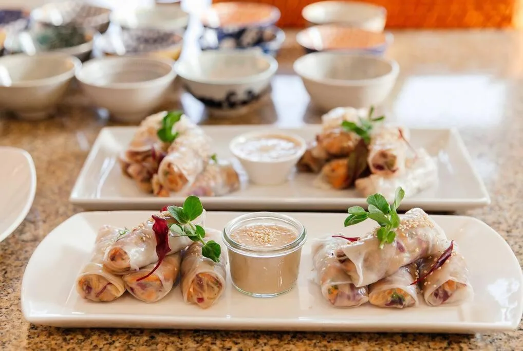Elegantly plated appetizers with sauce and microgreens on white platters