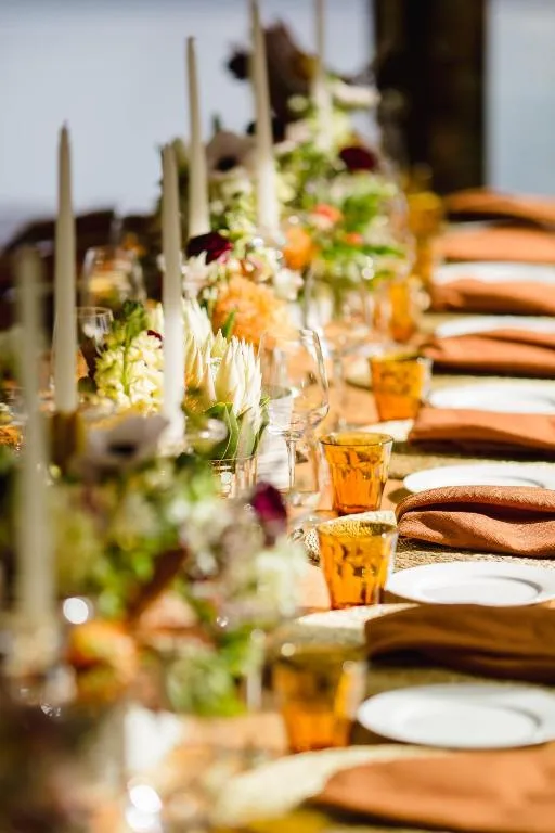 Elegant long dining table set with floral centerpieces and place settings