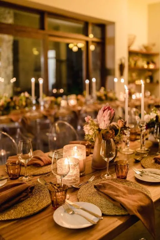 Elegantly set dining table with candles, flowers, and place settings