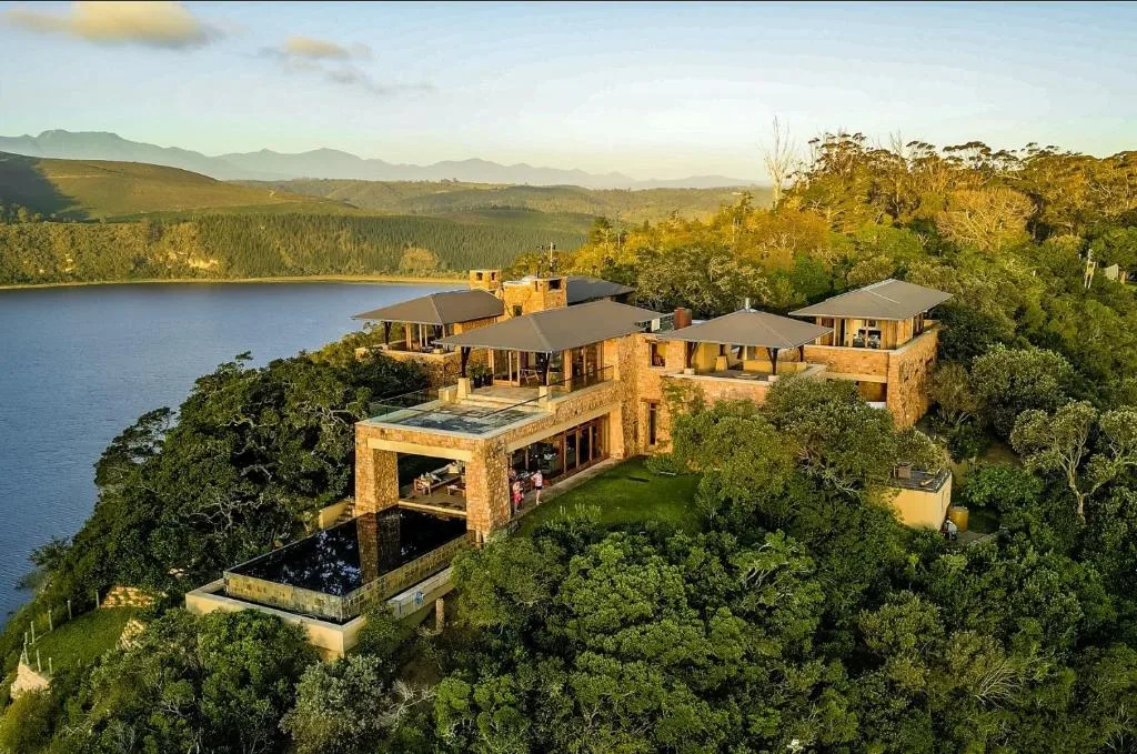 Luxury villa with stone facade overlooking lake and mountains