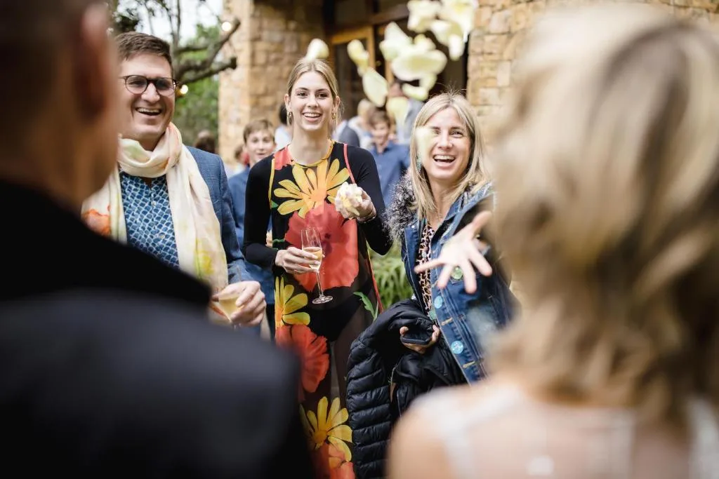 Guests enjoying drinks and conversation in the villa's courtyard garden area