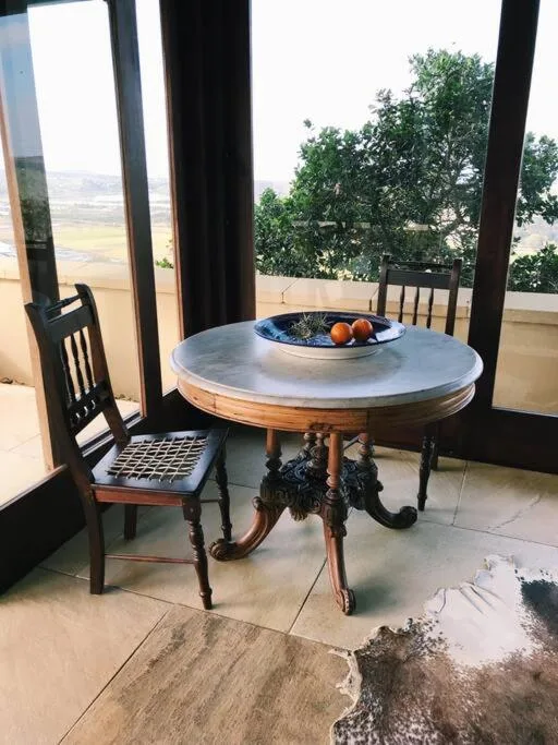 Circular table on deck with panoramic valley and farmland landscape view