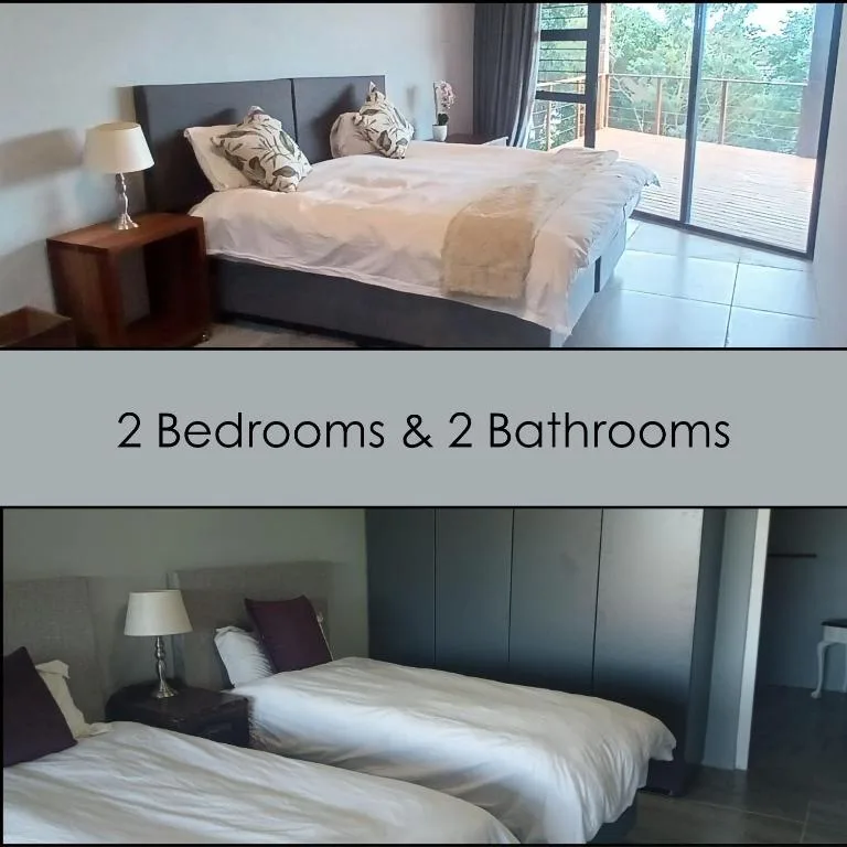 Spacious master bedroom with queen bed, dark headboard, garden views