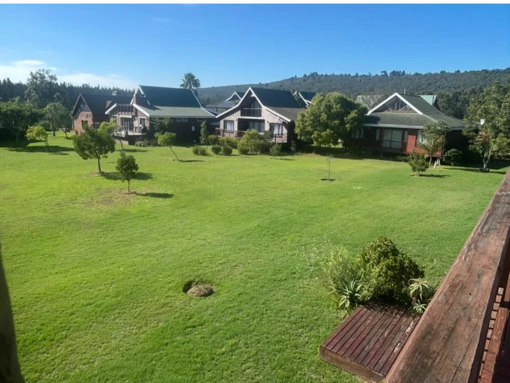 Large estate property with multiple gabled cottages and manicured green lawns