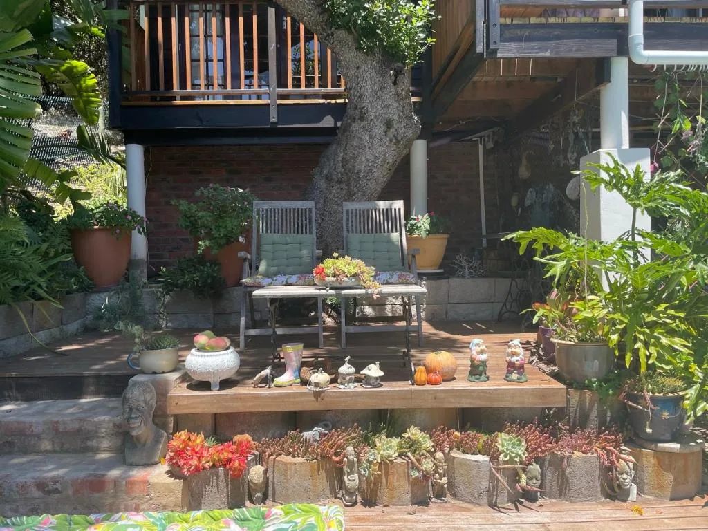 Outdoor patio with seating, potted plants, and garden decor elements