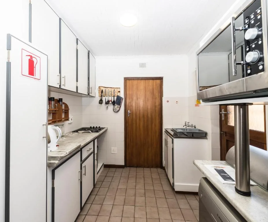 Modern kitchen with stainless steel appliances and white cabinetry