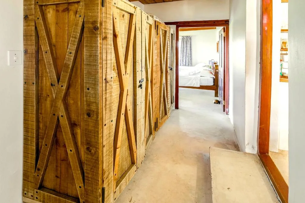 Rustic wooden barn doors line a hallway corridor interior