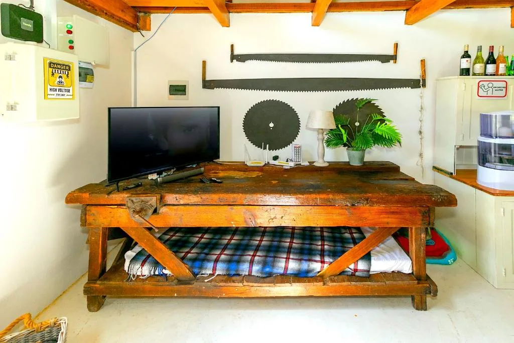 Rustic wooden workbench with storage and decorative wall art display