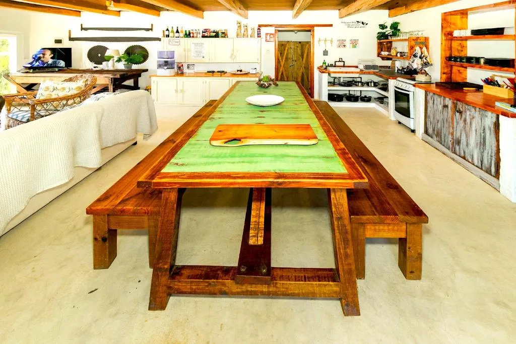 Rustic wooden ping-pong table in open-plan living and kitchen area