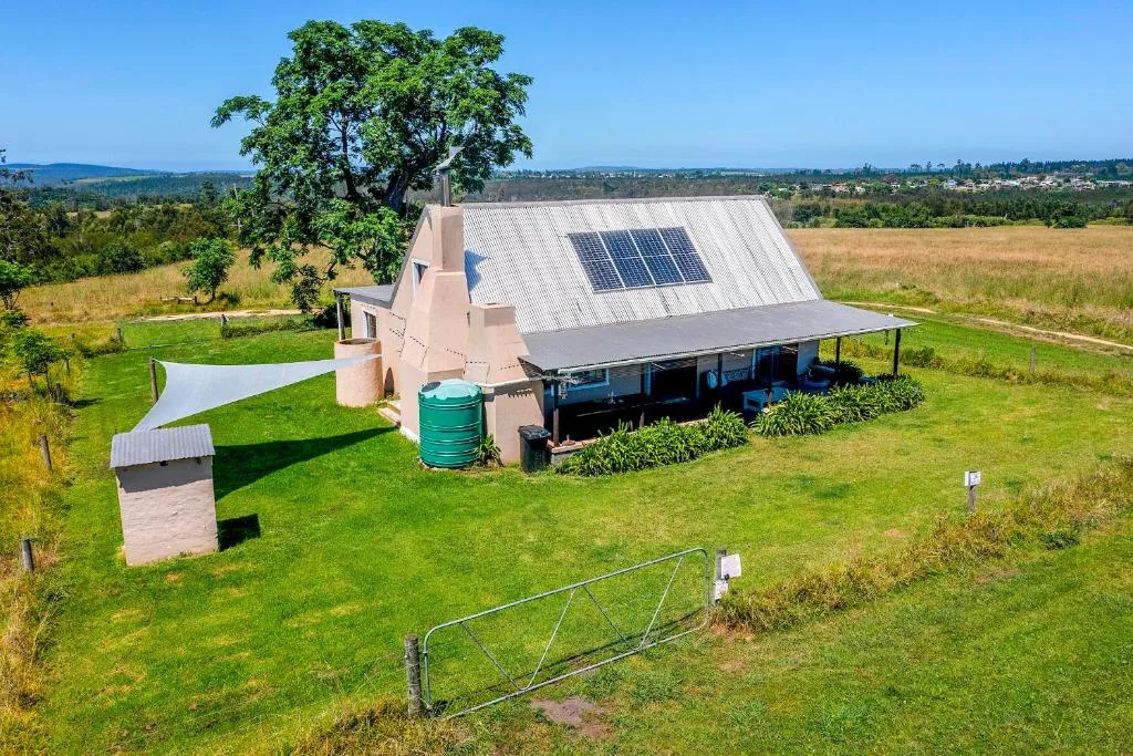 Modern pink cottage with solar panels and sprawling garden views