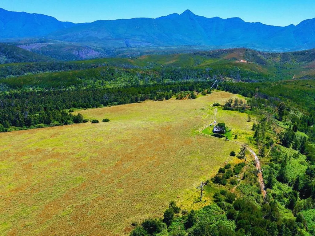 Dramatic mountain ranges and lush green valleys under clear blue sky