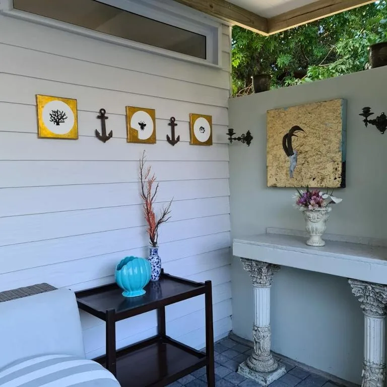 Coastal-themed entryway with nautical wall art and decorative accessories