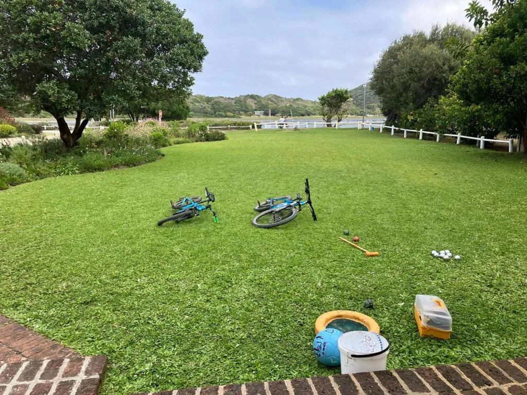 Spacious green lawn with recreational equipment and bicycles available