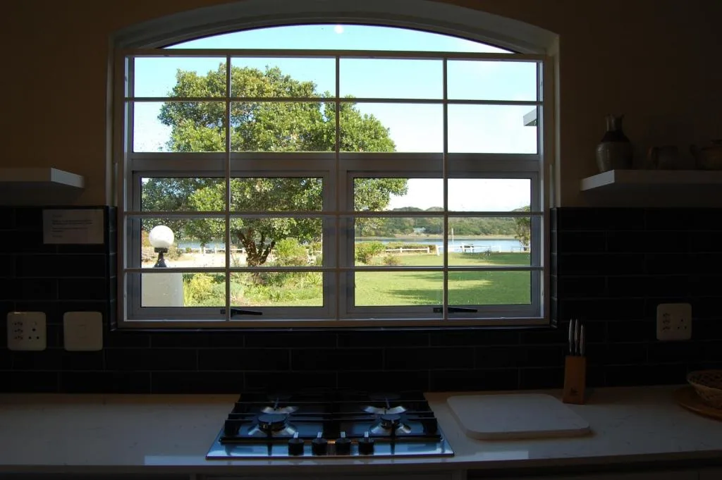 Kitchen window overlooking lush gardens and lagoon views in Sedgefield