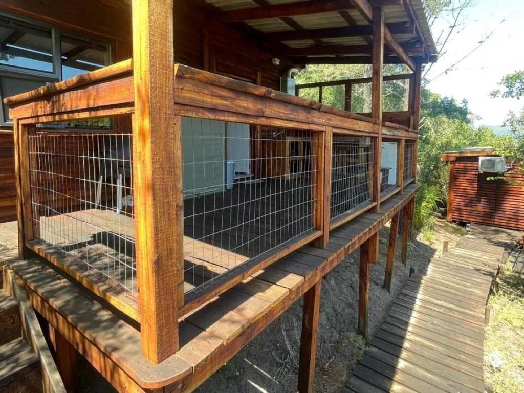 Wooden deck with sturdy railed enclosure overlooking lush garden surroundings
