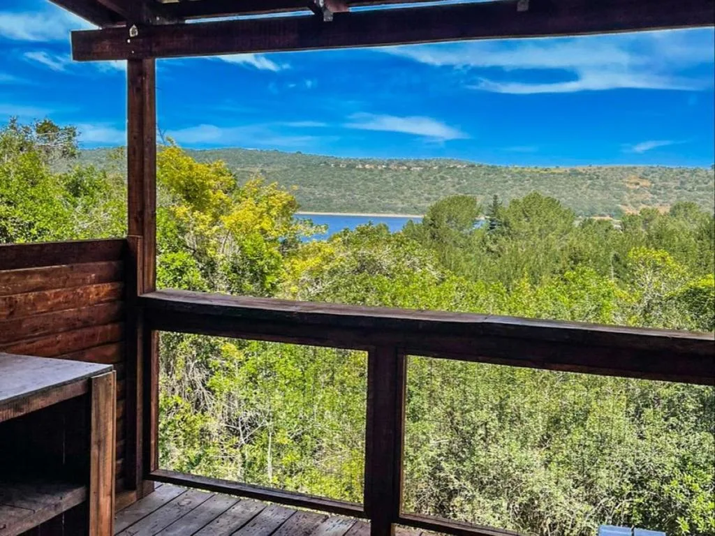 Scenic lagoon and mountain vista from wooden deck with railing
