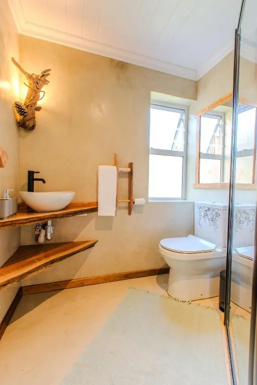 Modern bathroom with wooden vanity, vessel sink, and walk-in shower