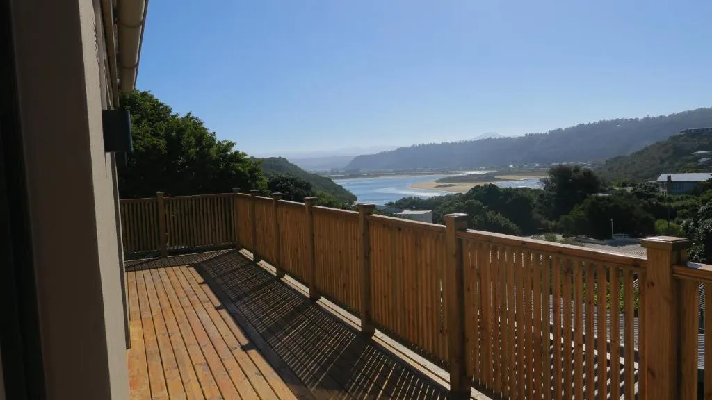 Wooden deck with lagoon and mountain views at sunrise
